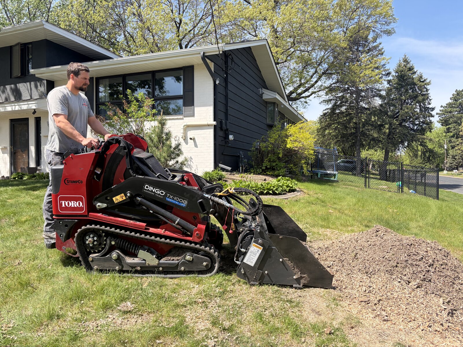 Toro Dingo with stump grinder attachment at a residential job